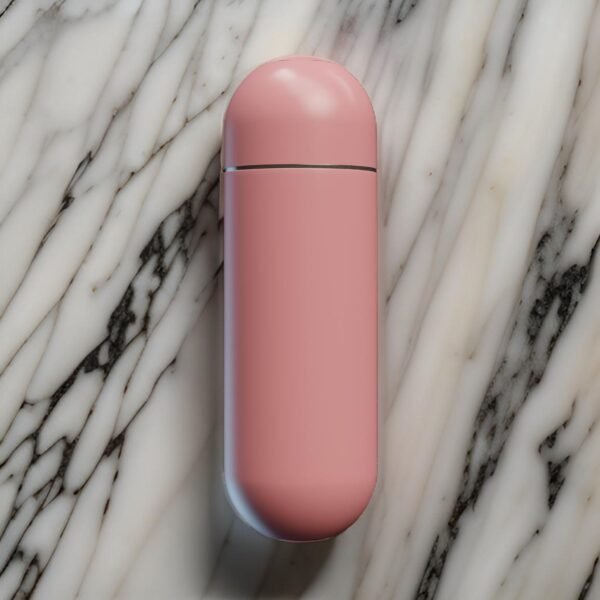 Closed pink portable bidet bottle on elegant marble background