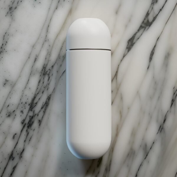 White portable bidet in closed position placed on marble countertop