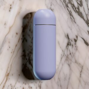 Closed purple portable bidet resting on a marble surface