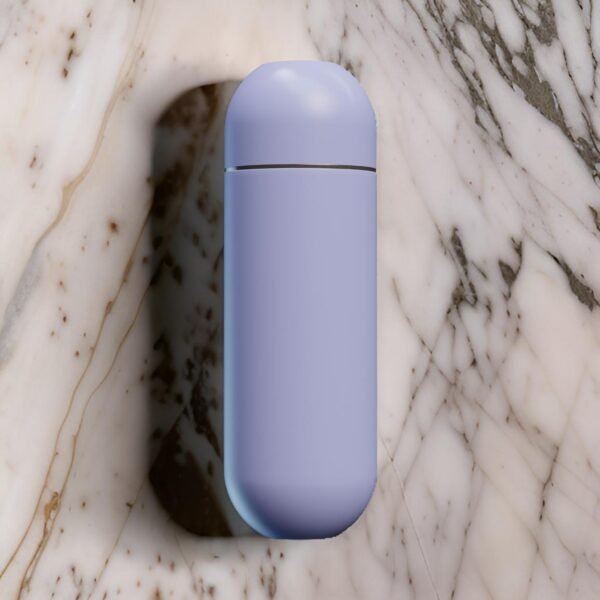 Closed purple portable bidet resting on a marble surface