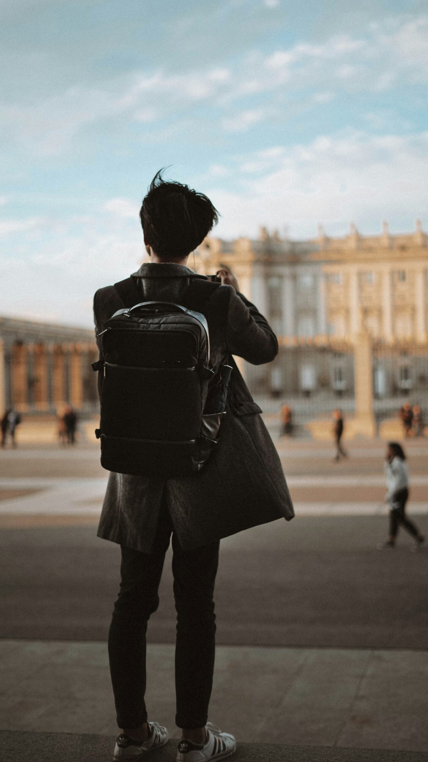 Male traveler with backpack exploring city